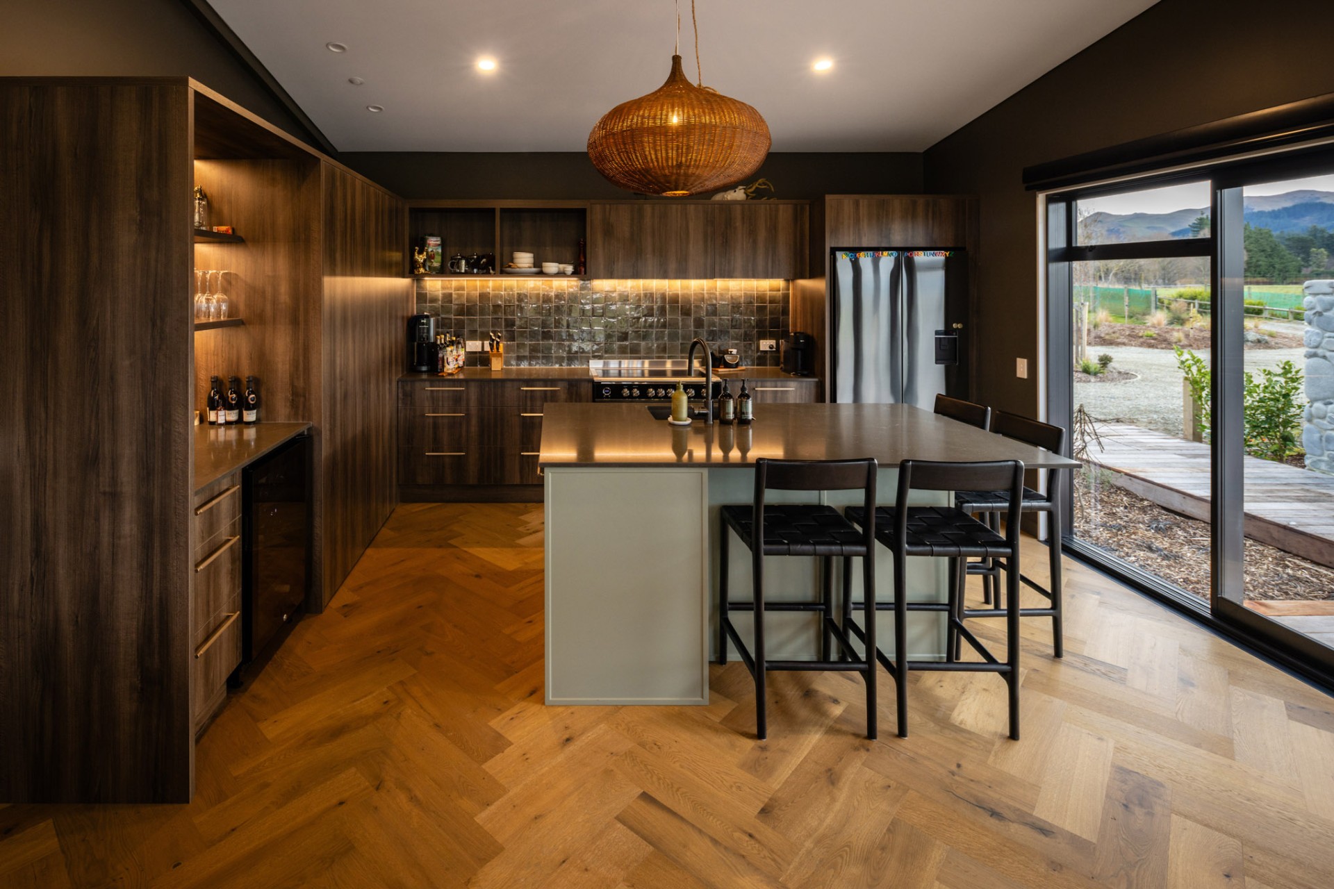 Timber kitchen with herringbone floor and mountain view at Whakahā