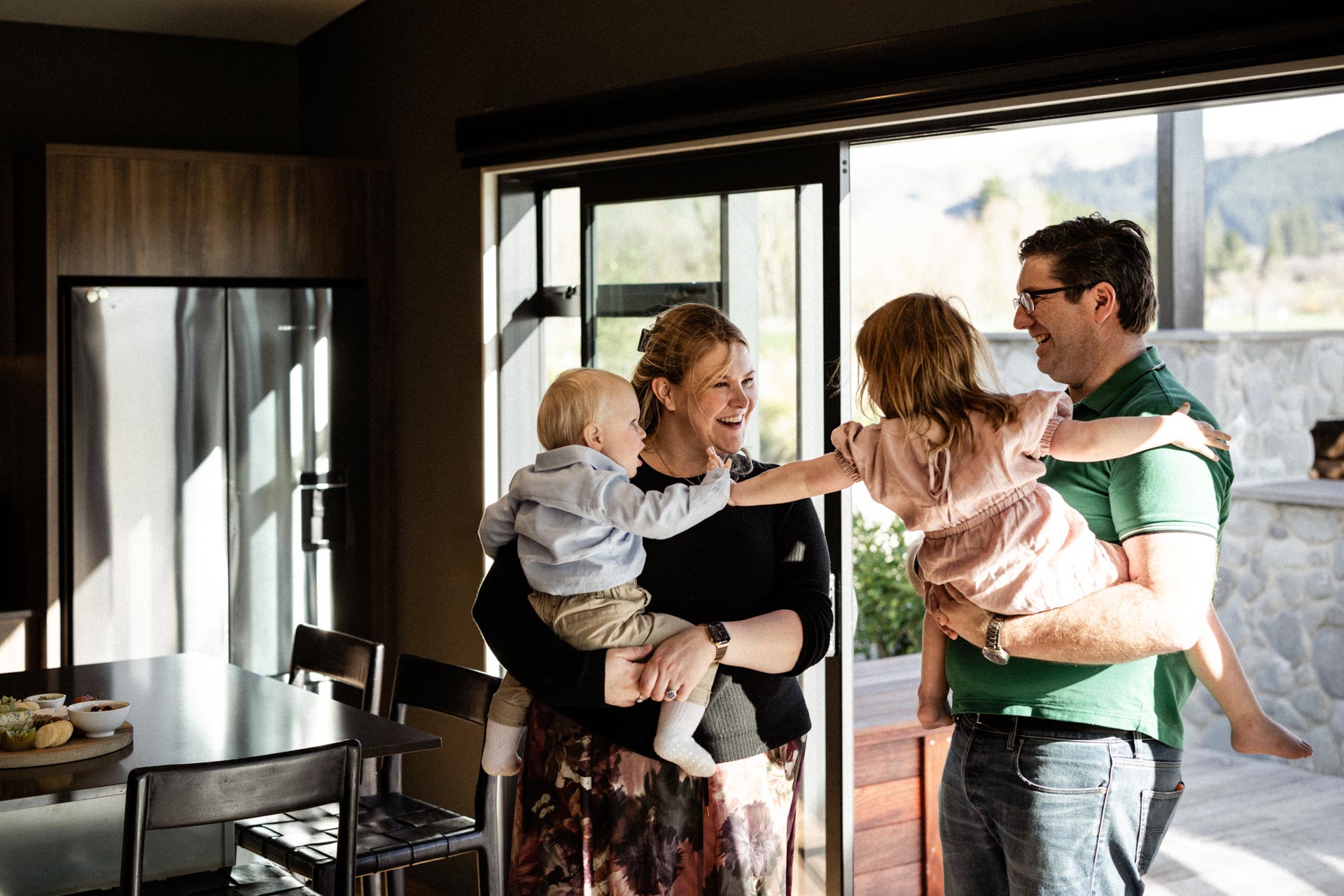 Camille and Chris Hughes with their children in the Whakahā kitchen