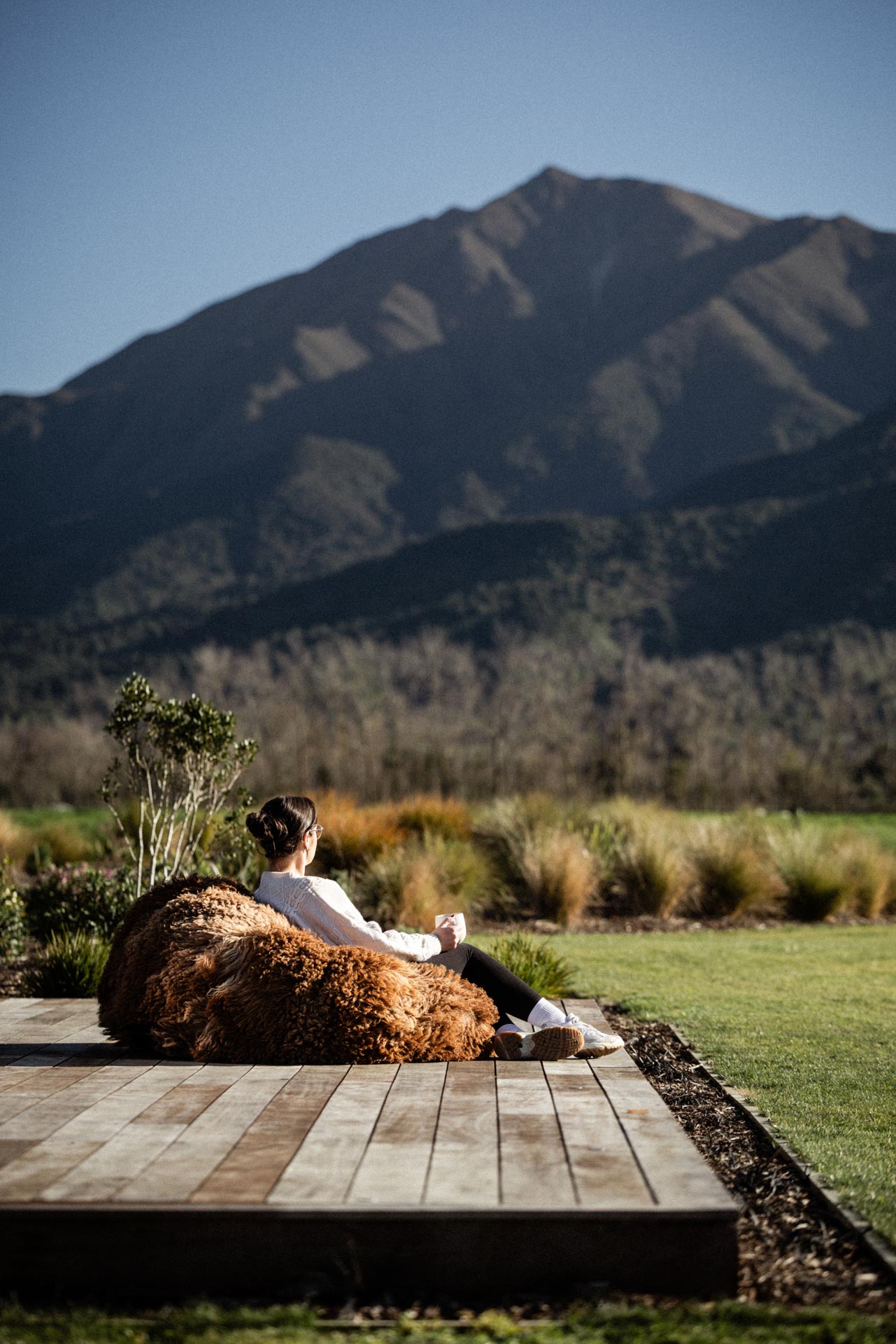 Resting on a sheepskin beanbag with Mt Peel rising beyond